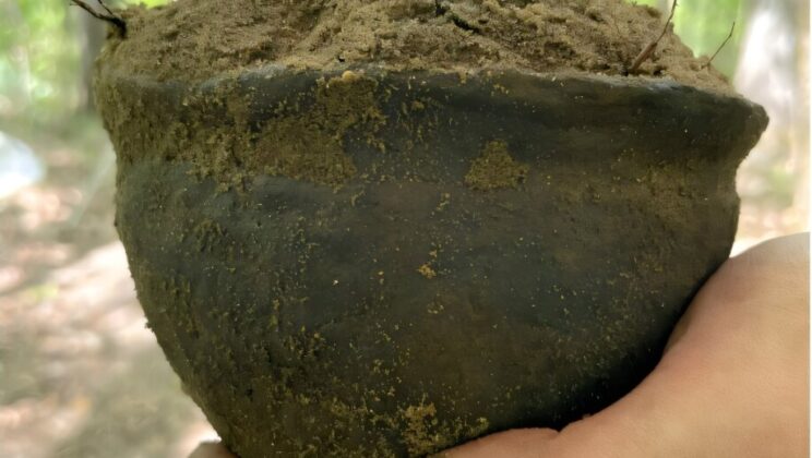 Nearly 400 years underground, a tiny clay pot survives intact with its purpose still unknown