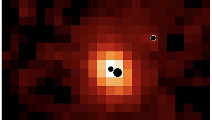 Three active black holes are packed into one distant galaxy